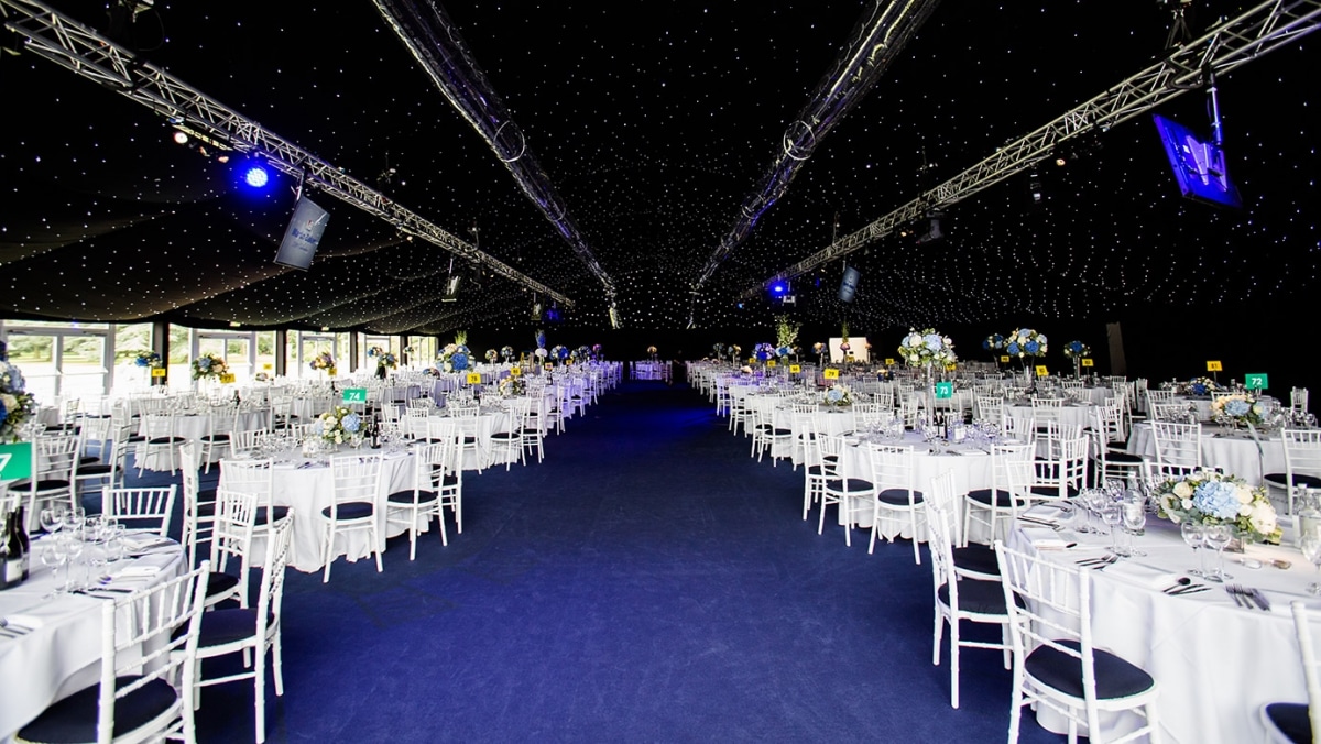Marquee with client’s corporate colours and star cloth ceiling